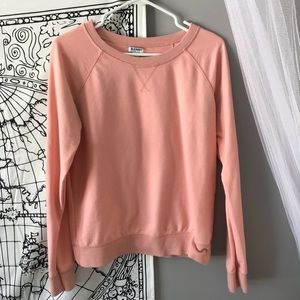 Peach colored longing crew neck sweatshirt